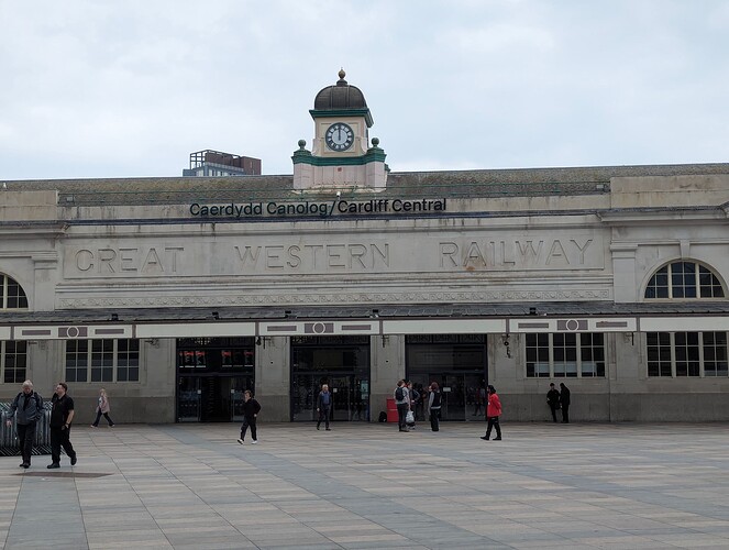 Entrance to a railway station on a Pixel 6 Pro phone, you can make out the Great Western Railway text on it and barely the station name. Some people are outside the station.
